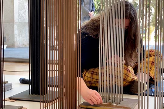 Conservator Claire Taggart with Harry Bertoia's sounding sculptures