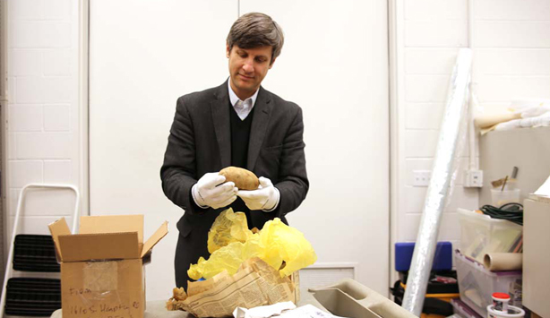 Chief Curator Jed Morse opening a package from Stephen Lapthisophon