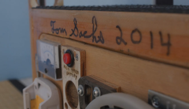 Installation view of a closeup of Tom Sachs' signature on Con-Ed barriers