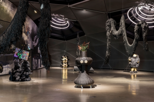 Installation image of sculptures from Yang's series Umbra Creatures by Rockhole, spotlit in a darkened space.