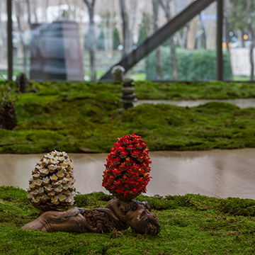 Two pinecone sculptures on a bed of moss